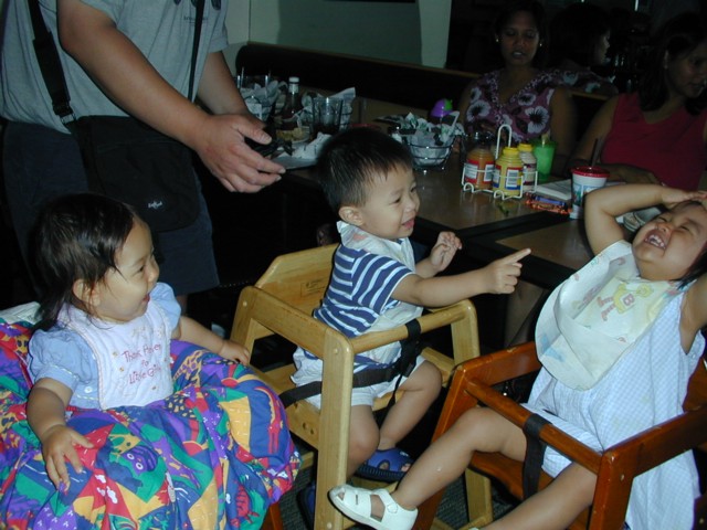 Three kids laughing together